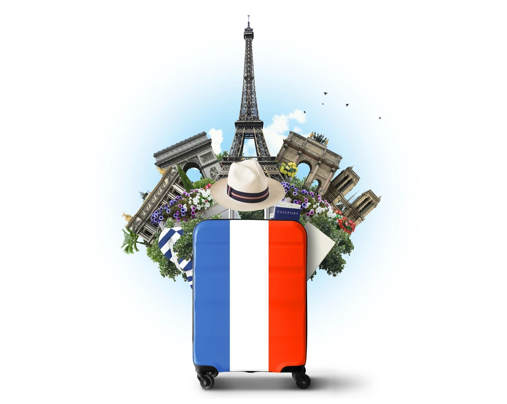 Suitcase decorated with French landmarks and flag, ready for travel to Paris.